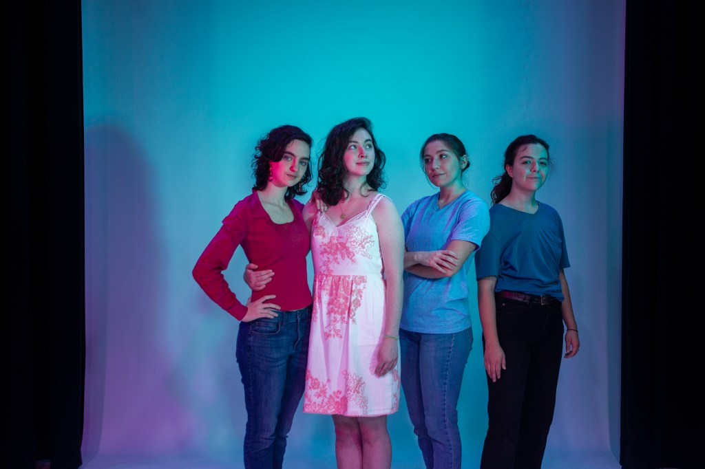 Image of the actors portraying Beatrice, Hero, Claudio, and Benedick in front of a blue background.